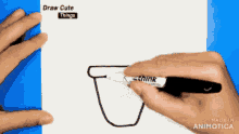 a person is using a sharpie marker to draw a cat
