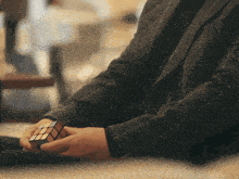 a man is holding a rubik 's cube in his hands
