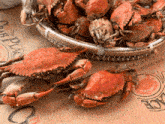 a basket of crabs sits on a table with a sign that says crab place