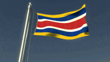 a flag with red white and blue stripes is flying in the wind
