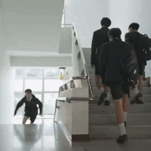 a group of people are walking up a set of stairs and one of them has a backpack that says ' abercrombie '