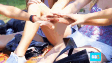 a group of people putting their hands together in a circle with a sbs logo in the background
