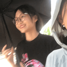 a girl wearing glasses and a black shirt that says adidas