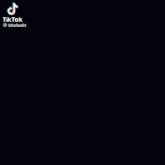 a close up of a woman 's face in the dark with a tiktok watermark