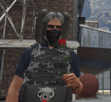 a person wearing a wolf patch on their vest holds a red rose