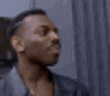 a close up of a man 's face with his eyes closed looking up .