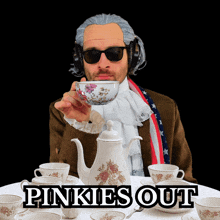 a man wearing a wig and sunglasses holds a cup of tea in front of a table with pinkies out written on the table
