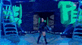 a woman is standing on a stage in front of a peacock logo and ladder .