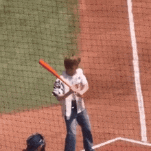 a baseball player with the number 27 on his back swings at a bat