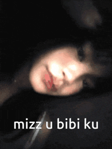 a close up of a woman 's face with the words mizzu bibi ku written below her