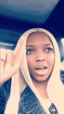 a woman with blonde hair is making a funny face
