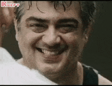 a close up of a man 's face with a smile on it .