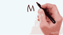 a hand is holding a pen with the words made in animatica on the bottom