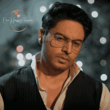a man wearing glasses and a vest with the words one happy occaan written in the corner
