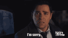 a woman says i 'm sorry in front of a heart & home logo