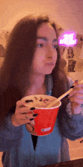 a woman eating a bowl of food with a spoon