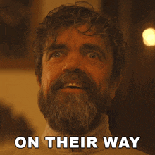 a man with a beard has on their way written on the bottom of his face