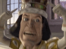 shrek is wearing a crown and holding a knife .