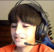 a young boy is wearing headphones and a microphone .