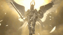 a statue of a woman with wings holding a sword and shield .