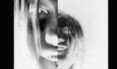 it is a black and white photo of a woman 's face .