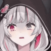 a close up of a girl wearing a hood with a heart on it