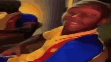 a blurry picture of a man in a yellow and blue jacket