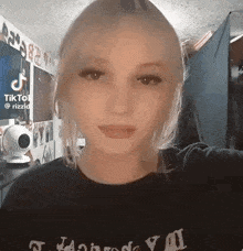 a young woman is taking a selfie in a room with a webcam .