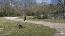 a man is riding a motorcycle down a road next to a generator .