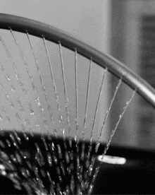a close up of a shower head with water coming out of it