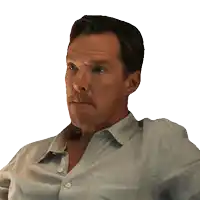 a man with a beard wearing a light blue shirt looks to the side