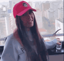 a woman wearing a pink hat has the letter p on her sweatshirt