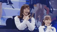 a girl with a microphone on her head is making a peace sign