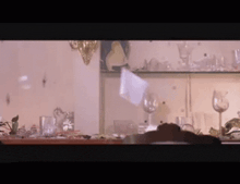a blurred image of a table with glasses and plates on it