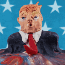 a statue of donald trump with a red tie
