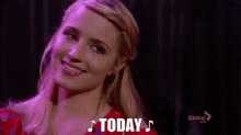 a woman in a red dress is singing a song and the word today is on the screen .