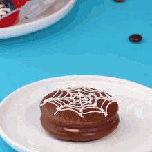 a chocolate cookie with a spider web on it