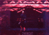 a man is dancing on a stage in front of a red background and a sign that says cmknight .