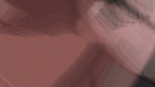 a close up of a person 's face with a blurred background