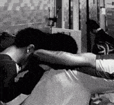 a black and white photo of two people laying down