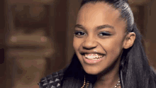 a girl with braces on her teeth is smiling