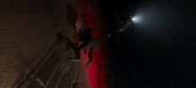 a person is climbing up a staircase with a light shining on them