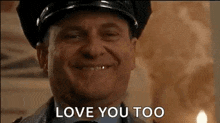 a police officer is smiling and saying `` love you too '' .