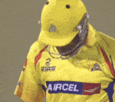 a man wearing a helmet and a yellow aircel jersey