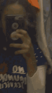 a person taking a selfie with a phone that says on