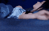 a woman is sleeping on a bed with a cat blanket