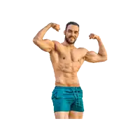 a shirtless man in blue swim shorts flexes his muscles