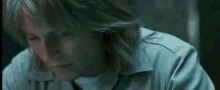 a close up of a person 's face in a dark room with their eyes closed .