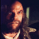 a man with long hair and a beard is tied up