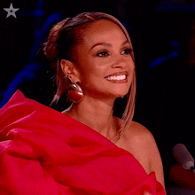 a woman in a red dress is smiling and clapping her hands with the words yay written below her